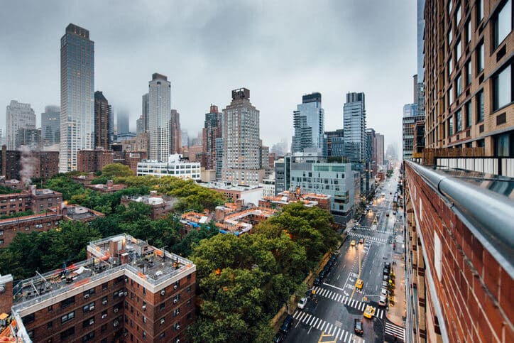 View of NYC street and skyline on a rainy day.